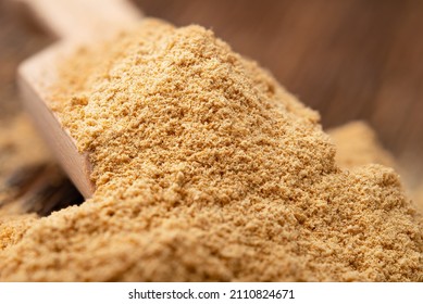 Dried Ginger Powder In A Wooden Scoop Close Up