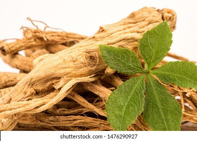 Dried Ginseng And Green Leaf On White Background.