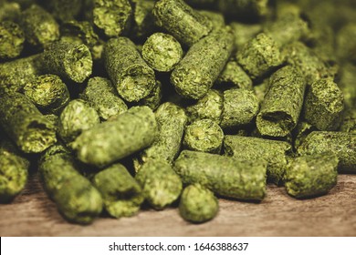 Dried Green Hop Pellets On Wooden Ground, Ingredient For A Brewery, Beer Plant Or Company, Closeup