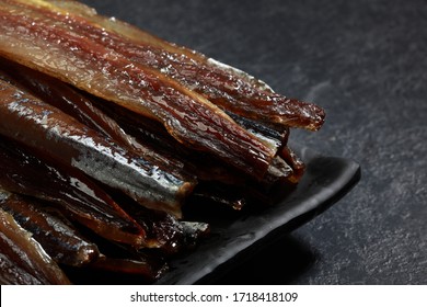 Dried herring photographed on a dark gray background