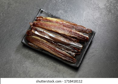 Dried herring photographed on a dark gray background