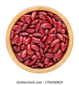 Dried kidney bean in wooden bowl isolated on white. Top view.