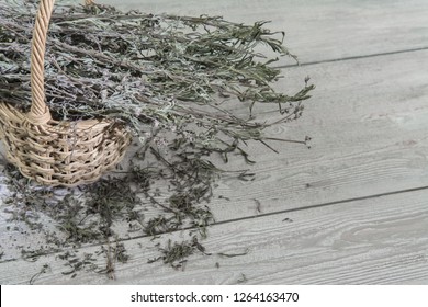Dried lavender in a basket on the gray table. Photo