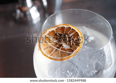A dried lime with herb on the cocktail glass in the pub.
