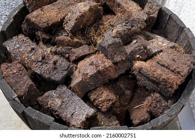 Dried Lumps Of Peat In Front Of A Whisky Distillery. Peat Is Used To Dry The Malted Barley. It Gives The Whisky A Distinctive Smoky Flavour.