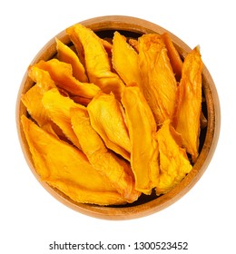 Dried Mango Slices In Wooden Bowl. Sliced, Dehydrated Mangoes. Juicy Tropical Stone Fruit With Yellow And Orange Color. Mangifera. Isolated Macro Food Photo, Closeup, From Above, On White Background.