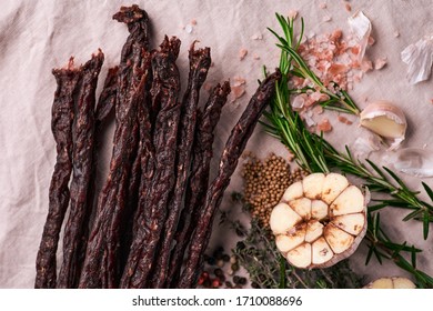 Dried Meat Beef Jerky On Tablecloth And Wooden Background
