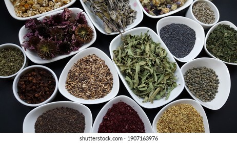 Dried medicinal aromatic herbs on black background in plate