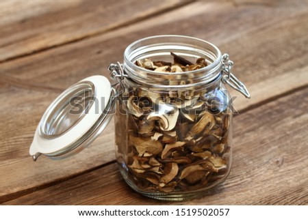 Dried mushrooms.  Boletus mushrooms in jar on the old wooden table 