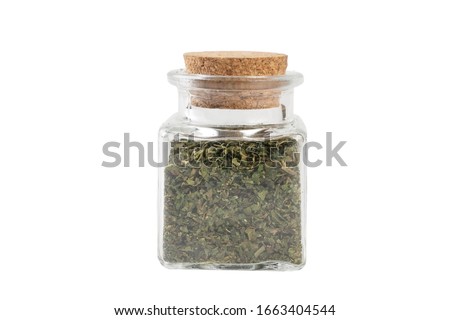 dried nettle herb or in latin Utricae folium in a glass jar isolated on white background. medicinal healing herbs. herbal medicine. alternative medicine