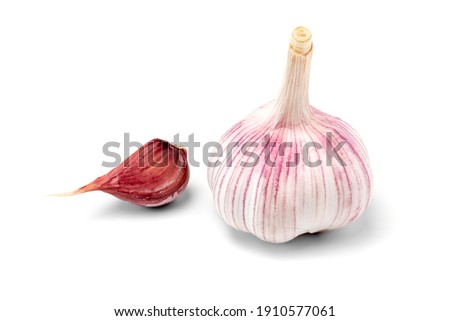 Dried onion of pink garlic and one clove of garlic isolated on a white background. A popular vegetable crop with a sharp taste and pungent smell