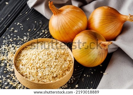 dried onions on a black wooden rustic background.
