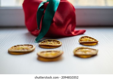 Dried Orange Slices On The Background Of A Red Bag With Sweets