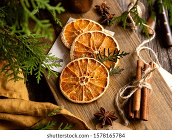 dried orange slices on wooden board with anise stars, cinnamon sticks, fir tree branches, ingredients for cooking or christmas decoration - Powered by Shutterstock