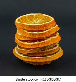 Сolumn of dried oranges on a black background
