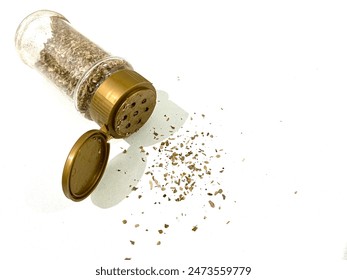 Dried oregano seasoning powder in a plastic shaker isolated on white background - Powered by Shutterstock