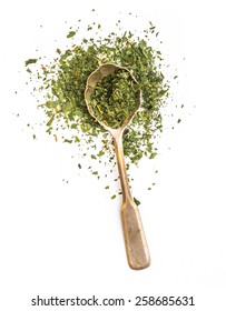 dried parsley in a spoon isolated on a white background