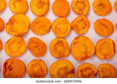 Dried Peach Isolated On White Background. Photo Wallpaper Pattern.