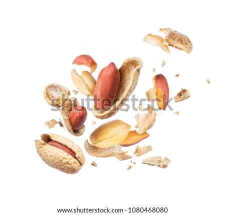 Dried peanut crushed in the air close-up on white background