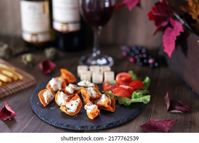 Dried persimmon and cream cheese hors d'oeuvre and wine - Powered by Shutterstock