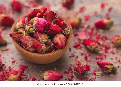 Dried Pink Rose Buds In A Brown Bowl