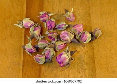 Dried Pink Rose Buds On Wood Background, Overhead View - Rosaceae