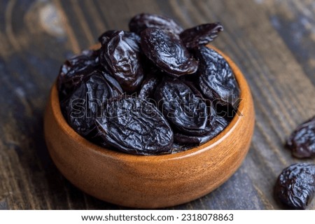 Dried plums on the kitchen table, dried sweet pitted prunes