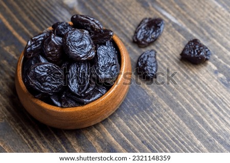 Dried plums on the kitchen table, dried sweet pitted prunes
