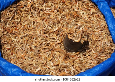 Dried Prawns/shrimps And A Measuring Vessel In A Plastic Sac, On Display In A Fish Market In Bangalore, Top Down View.                 