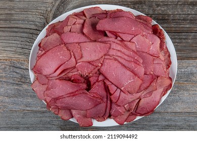 Dried Processed Beef Jerky Against A Background. Background Texture Of Several Pieces Beef Jerky. Close Up On Tasty Jerky Snack.