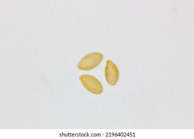 Dried Pumpkin Seeds In Husks. Yellow Pumpkin Seeds On A White Background. Isolated. Flat Oval Seed Of Squash. Edible Seed Of A Pumpkin. Healthy Food. Natural Product. Roasted Snack. Pepita. Close-up