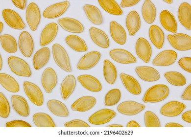 Dried Pumpkin Seeds In Husks. Yellow Pumpkin Seeds On A White Background. Isolated. Flat Oval Seed Of Squash. Edible Seed Of A Pumpkin. Healthy Food. Natural Product. Roasted Snack. Pepita. Close-up