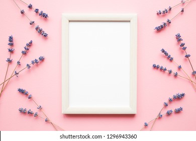 Dried purple lavender with blank white photo frame on pastel pink background. Mockup for positive idea. Empty place for inspirational, emotional, sentimental text, quote, sayings or picture. Flat lay.