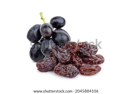 Dried raisins with fresh grape on white background