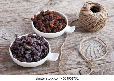 Dried Raisins Turkish And Spanish (Malaga). Turkish Raisins, Sultan Raisins Pitted . Raisins From Malaga With Stones. Dried Raisins On The Wood Backgraund