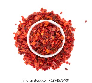 Dried Red Chili Flakes In Bowl, Isolated On White Background. Chopped Chilli Cayenne Pepper. Spices And Herbs. Top View.