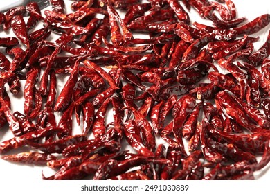 Dried red chili isolated on white background. Thai spice hot pepper chili ingredient cooking, top angle view drying chilis background - Powered by Shutterstock