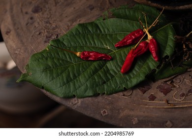 Dried Red Chilies On A Leaf Used For Cooking Shot In Low Light