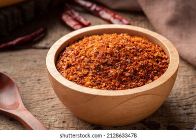 Dried Red Hot Chilli Powder In Wooden Bowl.Hot And Spicy Asian Condiments