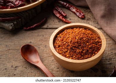 Dried Red Hot Chilli Powder In Wooden Bowl.Hot And Spicy Asian Condiments