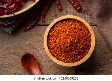 Dried Red Hot Chilli Powder In Wooden Bowl.Hot And Spicy Asian Condiments.Top View