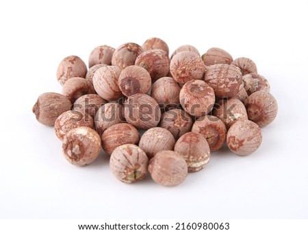 dried red lotus seeds on white background