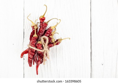 Dried Red Peppers On A White Barnwood Table