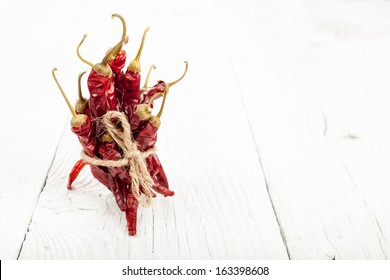 Dried Red Peppers On A White Barnwood Table