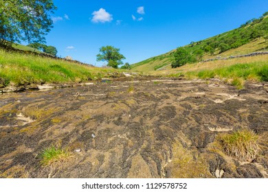 The dried up river bed of the River Wharfe at Hubberholme near Kettlewell in the Yorkshire Dales, UK, England, due to the prolonged heatwave in England with no rain for weeks, July 2018