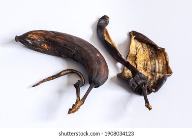 Dried Up Rotten Decomposed Banana And Peel On White Table - Concept And Idea Background