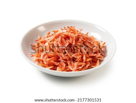 Dried sakura shrimps on a plate placed on a white background. Image of Japanese food. 