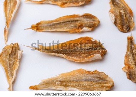 Dried salted fish for beer on a white background. Close-up.