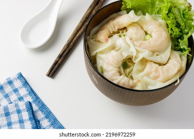 Dried Shrimp Wonton Noodle With Vegetable In A Bowl With Wooden Chopstick, Spoon, Blue Napkin On White Background. Top View Photo. Popular Menu In Restaurant Of Asian Such As Hong Kong, Chinese, Thai.