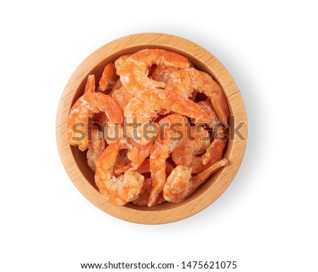 Dried shrimp in a wooden bowl on a white background. Top view